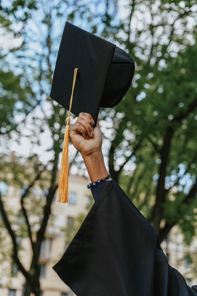 A Person Holding a Black Graduation Hat